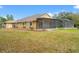 The backyard features mature trees and a large screened-in porch at 27930 Ravens Brook Rd, Wesley Chapel, FL 33544