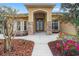 Inviting front entrance with stone accents and colorful flower bed at 27930 Ravens Brook Rd, Wesley Chapel, FL 33544