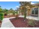 Up close view of the landscaping around the front entry and a side view of the home at 27930 Ravens Brook Rd, Wesley Chapel, FL 33544