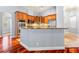 Modern kitchen with wood cabinets, granite countertops, stainless steel appliances, and hardwood floors at 27930 Ravens Brook Rd, Wesley Chapel, FL 33544