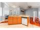 Kitchen view including granite countertops, a stainless steel dishwasher, and wood floors at 27930 Ravens Brook Rd, Wesley Chapel, FL 33544