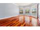Living room showcasing hardwood floors, large windows with backyard pool views at 27930 Ravens Brook Rd, Wesley Chapel, FL 33544
