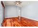 Spacious living room with hardwood floors, a ceiling fan, and a double-door entry way at 27930 Ravens Brook Rd, Wesley Chapel, FL 33544