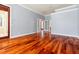 Spacious living room featuring hardwood floors, neutral paint, and multiple entry points at 27930 Ravens Brook Rd, Wesley Chapel, FL 33544