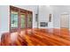 Hardwood floors highlight a living room featuring a fireplace and french doors at 27930 Ravens Brook Rd, Wesley Chapel, FL 33544