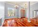 Living room featuring hard wood floors, high ceilings, and large windows at 27930 Ravens Brook Rd, Wesley Chapel, FL 33544