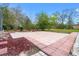 A brick-paved patio with green grass and a garden bed at 27930 Ravens Brook Rd, Wesley Chapel, FL 33544