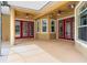 Spacious outdoor patio area with multiple doors to backyard and fans for air circulation at 27930 Ravens Brook Rd, Wesley Chapel, FL 33544