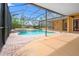 Stunning outdoor pool area with a screened enclosure, patio, and a tranquil spa at 27930 Ravens Brook Rd, Wesley Chapel, FL 33544