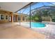 Outdoor pool area featuring a pool, screened enclosure, and a spacious patio, perfect for relaxation at 27930 Ravens Brook Rd, Wesley Chapel, FL 33544