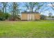 An outdoor shed located in the backyard with green grass at 27930 Ravens Brook Rd, Wesley Chapel, FL 33544