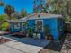 Stylish home with a blue exterior, featuring a landscaped front yard and a concrete walkway at 2926 W Elrod Ave, Tampa, FL 33611