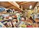 Unfinished basement with exposed rafters, lots of storage, and clutter at 3112 S Julia Cir, Tampa, FL 33629