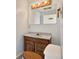 Bathroom with wooden vanity, a large mirror, and three-bulb vanity lighting at 3112 S Julia Cir, Tampa, FL 33629