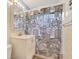 Bathroom with a patterned shower curtain, white vanity, mirrored medicine cabinet, and tile flooring at 3112 S Julia Cir, Tampa, FL 33629