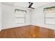 Bedroom featuring wood flooring, fan, and windows with curtains at 3112 S Julia Cir, Tampa, FL 33629