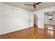 Bedroom featuring wood flooring, fan, and mirrored closet at 3112 S Julia Cir, Tampa, FL 33629