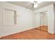 Bedroom featuring wood flooring, fan, and mirrored closet at 3112 S Julia Cir, Tampa, FL 33629