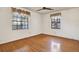 Bedroom featuring wood flooring, fan, and windows with curtains at 3112 S Julia Cir, Tampa, FL 33629