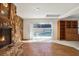 Open-concept living room with fireplace, hardwood floors, and sliding glass doors to the pool area at 3112 S Julia Cir, Tampa, FL 33629