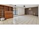 Open living room with tile flooring, built-in bookcase, and a large window to the exterior at 3112 S Julia Cir, Tampa, FL 33629