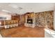 Charming living room with a rustic fireplace, built-in bar area, parquet floors, and recessed lighting at 3112 S Julia Cir, Tampa, FL 33629