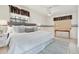 Serene main bedroom with a large window, ceiling fan, neutral decor, and tile floors at 3112 S Julia Cir, Tampa, FL 33629