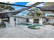 The screened in pool and spa are surrounded by a spacious concrete deck at 3112 S Julia Cir, Tampa, FL 33629