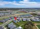 New home community aerial view showing a home location on a large lot with mature tree at 31999 Surfton Knot Ct, San Antonio, FL 33576