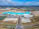 Wide aerial view showcasing the lagoon amenity and new construction at 31999 Surfton Knot Ct, San Antonio, FL 33576
