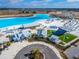 Aerial view of community clubhouse, green space, and pool surrounded by lush landscaping at 31999 Surfton Knot Ct, San Antonio, FL 33576