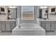 Bathroom featuring a soaking tub, dual vanities, and subway tile at 31999 Surfton Knot Ct, San Antonio, FL 33576