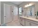 Bathroom featuring double vanity with white countertop and a walk-in shower at 31999 Surfton Knot Ct, San Antonio, FL 33576