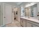 Bright bathroom with tile flooring, grey vanity, and a walk-in shower at 31999 Surfton Knot Ct, San Antonio, FL 33576