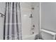 Well-maintained bathroom with a shower-tub combination, complemented by neutral tones and a shower curtain at 31999 Surfton Knot Ct, San Antonio, FL 33576