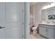 Neat bathroom featuring a vanity and toilet, and a view of the shower at 31999 Surfton Knot Ct, San Antonio, FL 33576