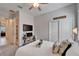 Cozy bedroom featuring a ceiling fan, a TV mounted on the wall and a comfortable bed with decorative pillows at 31999 Surfton Knot Ct, San Antonio, FL 33576