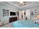 Bright bedroom offers a tray ceiling, plenty of shelving, and neutral colored walls at 31999 Surfton Knot Ct, San Antonio, FL 33576