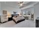 Spacious bedroom features tray ceilings, comfortable seating, and ample natural light from large windows at 31999 Surfton Knot Ct, San Antonio, FL 33576