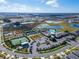 Panoramic aerial view showcasing the community's pools, tennis courts, and scenic water features at 31999 Surfton Knot Ct, San Antonio, FL 33576