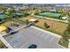 Aerial view of the community playground, tennis courts, parking lot and open lawn space at 31999 Surfton Knot Ct, San Antonio, FL 33576