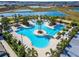 Aerial view of a resort-style community pool with ample lounging and lush landscaping at 31999 Surfton Knot Ct, San Antonio, FL 33576
