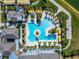 Aerial view of a sprawling resort-style pool with a central island and surrounding lounge areas at 31999 Surfton Knot Ct, San Antonio, FL 33576