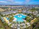 Aerial view of a luxurious community pool surrounded by palm trees and inviting amenities at 31999 Surfton Knot Ct, San Antonio, FL 33576