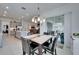 Dining area near kitchen and living area with chandelier and sliding glass doors at 31999 Surfton Knot Ct, San Antonio, FL 33576