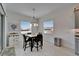 Dining area features modern chandelier, natural light, and tile floors at 31999 Surfton Knot Ct, San Antonio, FL 33576