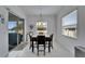Bright dining room features a modern light fixture and view to the exterior at 31999 Surfton Knot Ct, San Antonio, FL 33576