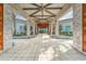 Grand entrance with stone columns, a covered walkway, and beautifully landscaped surroundings at 31999 Surfton Knot Ct, San Antonio, FL 33576