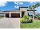 Beautiful home featuring a paver driveway, a three-car garage, and lush landscaping at 31999 Surfton Knot Ct, San Antonio, FL 33576