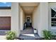 Welcoming front porch featuring brick pavers, neutral columns, and a decorative front door at 31999 Surfton Knot Ct, San Antonio, FL 33576